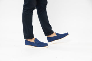 Ted Baker, Isaacc, Navy blue suede loafers with stitching detailing and white soles styled with jeans and modelled with feet and legs, The Shoe Curator