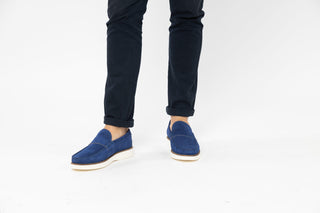 Ted Baker, Isaacc, Navy blue suede loafers with stitching detailing and white soles styled with jeans and modelled with feet and legs, The Shoe Curator