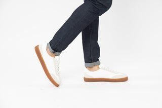 Ted Baker, Robbert, White leather sneakers with tan soles and cream suede details styled with jeans and modelled with feet and legs, The Shoe Curator